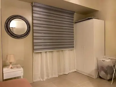 a room with a window with a window blind at Vacation at Tolentino Residence in Manila