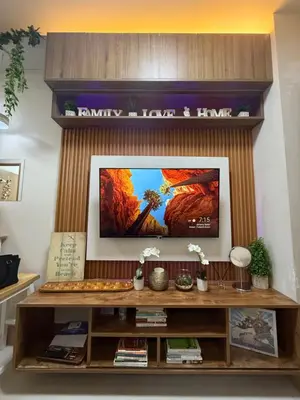 a living room with a flat screen tv on a wall at Shore Bliss Staycation in Manila