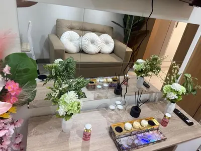 a reflection of a living room with a couch and flowers at stylish 2BR Condo Near NAIA in Manila