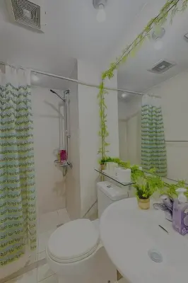 a bathroom with a toilet and a sink at Cheapest staycation miami tower azure in Manila