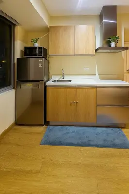 a kitchen with a sink and a refrigerator at Cheapest staycation miami tower azure in Manila