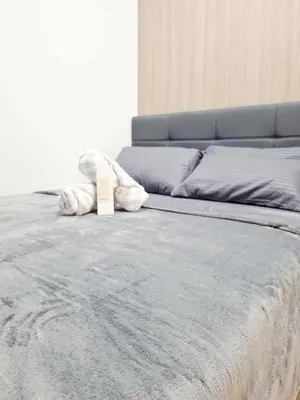 a close up of a bed with a sign on it at Oasis at Shore Residences in Manila