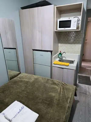 a small kitchen with a sink and a microwave at Staycation All In in Manila