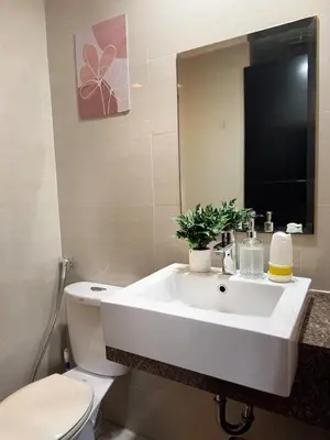 a bathroom with a sink and a toilet and a mirror at 81 Newport Across International Airport Terminal 3 C1-7O in Manila