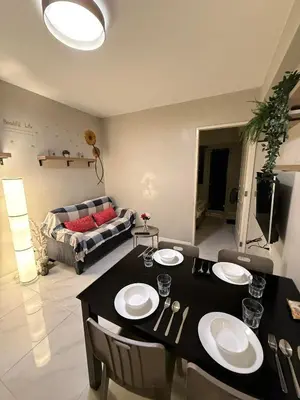 a living room with a table and a couch at 1BR Condo with balcony near MOA,Parqal,Solaire in Manila