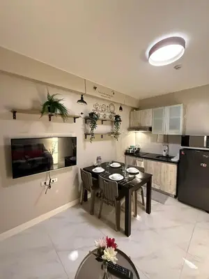 a kitchen and dining room with a table and chairs at 1BR Condo with balcony near MOA,Parqal,Solaire in Manila
