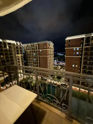 a balcony with a view of a city at night at 1BR Condo with balcony near MOA,Parqal,Solaire in Manila