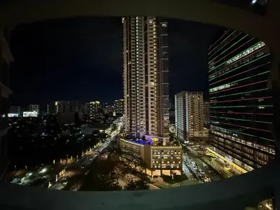 a view of a city at night with traffic at Condo in BGC by MichVist - Uptown Parksuites Tower 2 in Manila