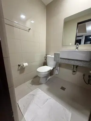 a bathroom with a toilet and a sink and a mirror at Condo in BGC by MichVist - Uptown Parksuites Tower 2 in Manila