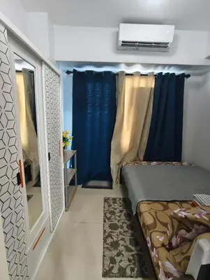 a small bedroom with a bed and a window at Juliza's MOA Staycation in Manila