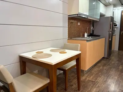 a small kitchen with a small table and chairs at Elegant BGC 1BR Staycation One Uptown Residence in Manila
