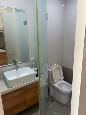 a bathroom with a sink and a toilet with a mirror at Comfy Studio for 2 at Sunshine100 in Mandaluyong Fully equipped in Manila