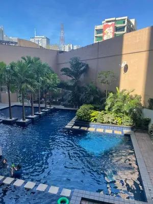a swimming pool in the middle of a building at Comfy Studio for 2 at Sunshine100 in Mandaluyong Fully equipped in Manila