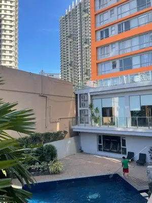 a man is standing on the roof of a building at Comfy Studio for 2 at Sunshine100 in Mandaluyong Fully equipped in Manila