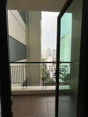 an open door to a balcony with a view of a city at Elements Residences 1br fully furnished with balcony in Manila