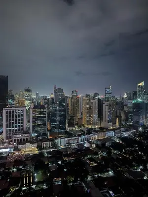 a view of a city at night with at Pure Elegance 1BR Suite in Manila
