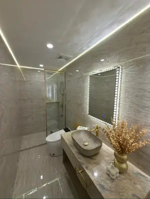 a bathroom with a sink and a toilet and a shower at Pure Elegance 1BR Suite in Manila