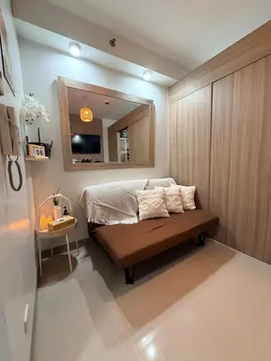 a small bedroom with a bed and a mirror at Pool View Condo near NAIA, SMX Netflix, WiFi, PS4 in Manila
