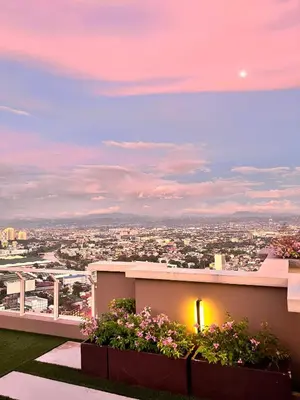 a view from the rooftop of a building with flowers at Chill Escape Prisma near BGC and Ortigas in Manila
