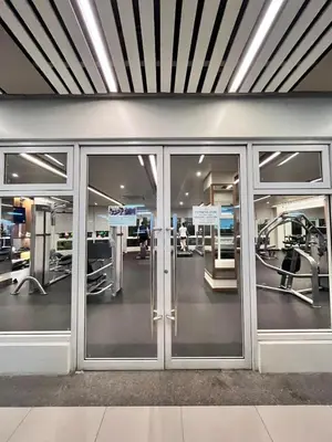 a gym with sliding glass doors in a building at Chill Escape Prisma near BGC and Ortigas in Manila