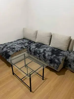 a couch with a table in a living room at Transient Home by Molave in Manila