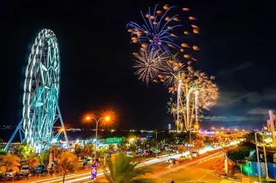 a large ferris wheel in a city at night at RM A837 S Residence near SMX and SM Arena in Manila