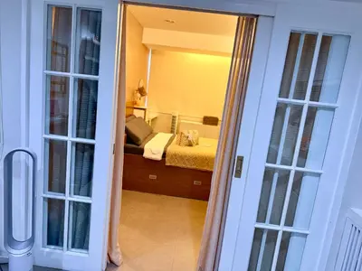 a view of a bedroom with a bed and a mirror at Affordable, Cozy & Quiet 1BR in BGC - Ideal for Short & Long Stays in Manila