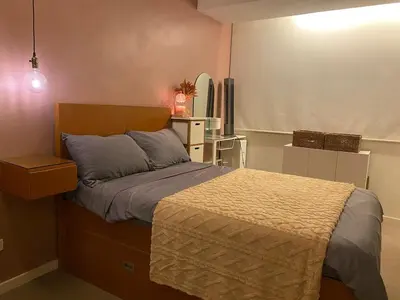 a small bedroom with a bed and a mirror at Affordable, Cozy & Quiet 1BR in BGC - Ideal for Short & Long Stays in Manila