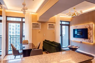 a living room with a couch and a table at Premium Condo units at Gentry Manor beside Okada Manila and near Airport in Manila