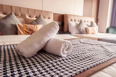 two rolls of toilet paper on a bed at Elegant Condo at ETON Baypark Manila in Manila