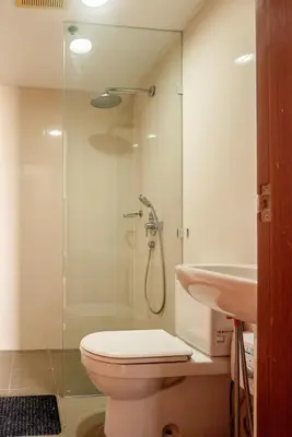 a bathroom with a shower and a toilet and a sink at Elegant Condo at ETON Baypark Manila in Manila