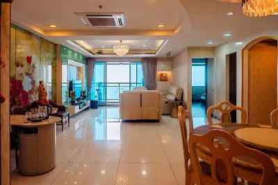 a living room with a table and a dining room at Classic-style Top Floor In Manila Bay in Manila