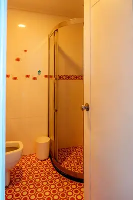 a bathroom with a shower and a toilet at Classic-style Top Floor In Manila Bay in Manila