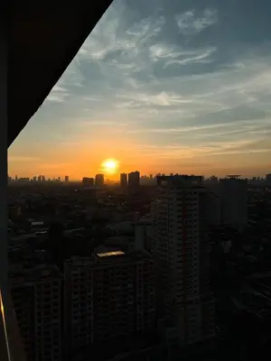 a view of the sunset from a building at Stylish & Serene Penthouse in Manila
