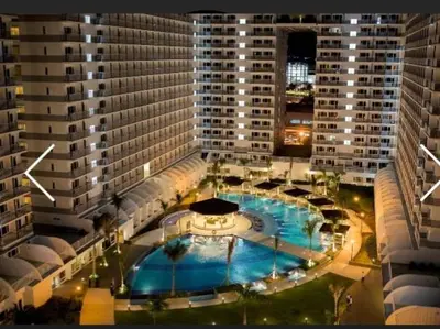 an overhead view of a large building with a swimming pool at Shell Residences Condo in Manila