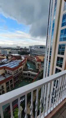 a view of a city from a balcony of a building at Venice Condotel in Manila
