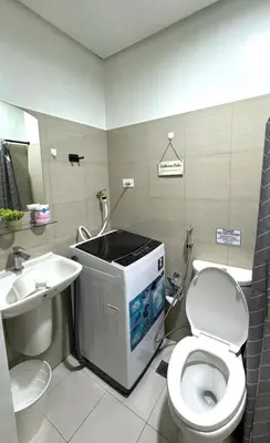 a bathroom with a toilet and a sink at Shore Residences in Pasay Manila, near Mall of Asia and Manila Airport in Manila