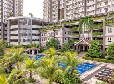 an apartment complex with a swimming pool and palm trees at Shore Residences in Pasay Manila, near Mall of Asia and Manila Airport in Manila