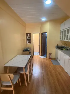 a kitchen and dining room with a table and chairs at Apt101 Guest House in Bacoor