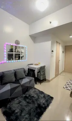 a living room with a couch and a table at Ellain's Cozy Staycation-SMDC Green 2 Residences in Dasmariñas