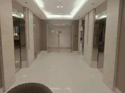 a hallway with a white floor in a building at Sea Residences Golden escape condotel in Manila