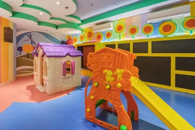 a play room with a slide and a play house at Admiral Baysuites 2602 in Manila