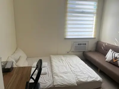 a small room with a bed and a couch at UDCT Condo Hotel in Manila in Manila