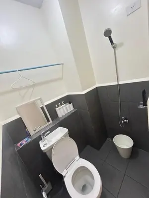 a small bathroom with a toilet and a shower at UDCT Condo Hotel in Manila in Manila