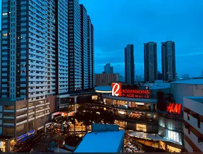 a view of a building in a city at night at Manila Skyview suite at Birch tower condo in Manila