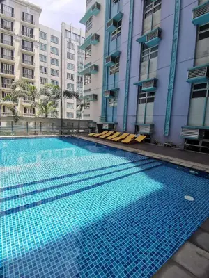a swimming pool in front of some buildings at A&G Condotel Right Across NAIA Terminal 3 in Manila