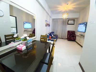 a living room with a dining table and a living room at A&G Condotel Right Across NAIA Terminal 3 in Manila