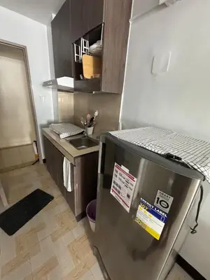 a kitchen with a stainless steel refrigerator and a sink at Just for sleeps in Manila
