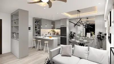 a living room and kitchen with a white couch at Staycation by Carmen Romualdo in Manila