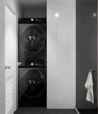 two washing machines in a room with a doorway at Staycation by Carmen Romualdo in Manila